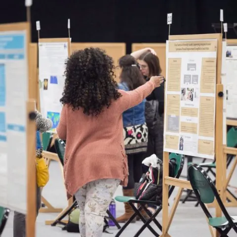 student presenting at research fair